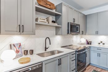 A kitchen with blue cabinets and a sink